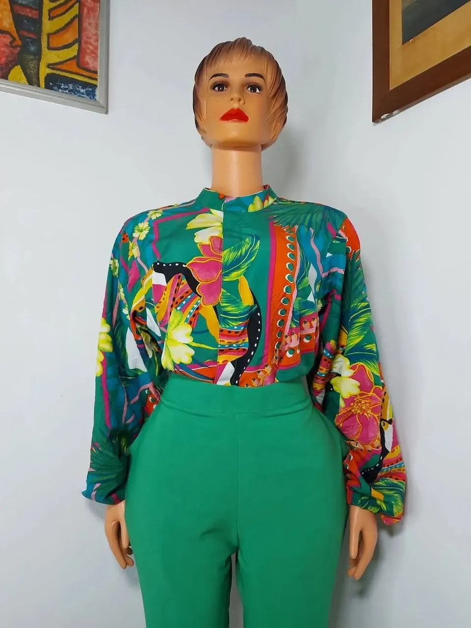 Tropical print blouse and green trousers